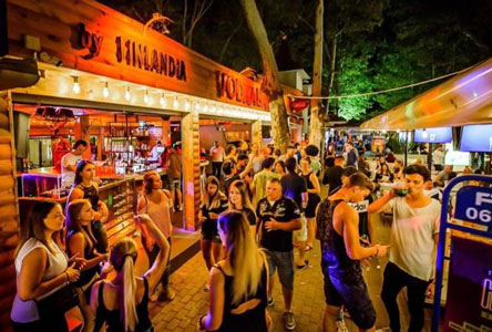The lit-up bar street in Siófok at night, busy with people — about 1 km from the hotel