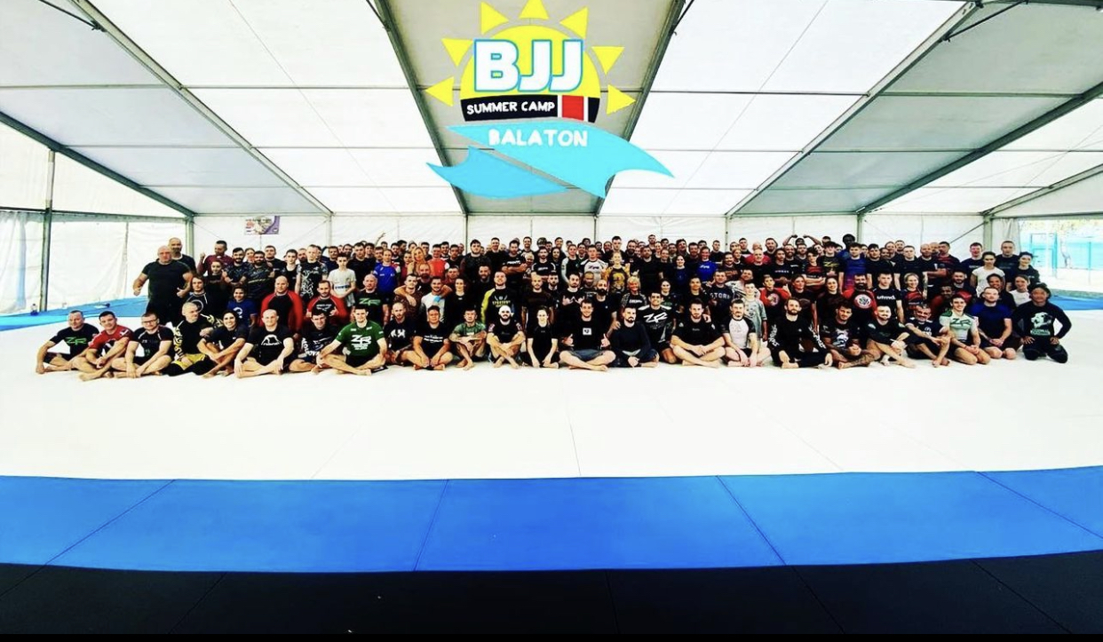 Practitioners training together on the outdoor mat at the Balaton BJJ Summer Camp